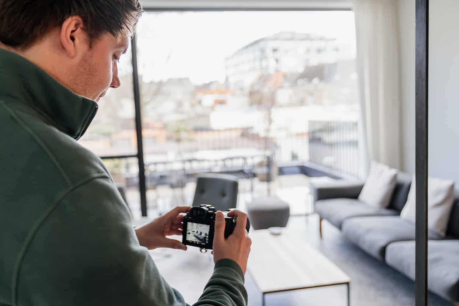 Fotograaf maakt interieurfoto van een lichtrijke, opgeruimde woonkamer om de verkoopwaarde te verhogen